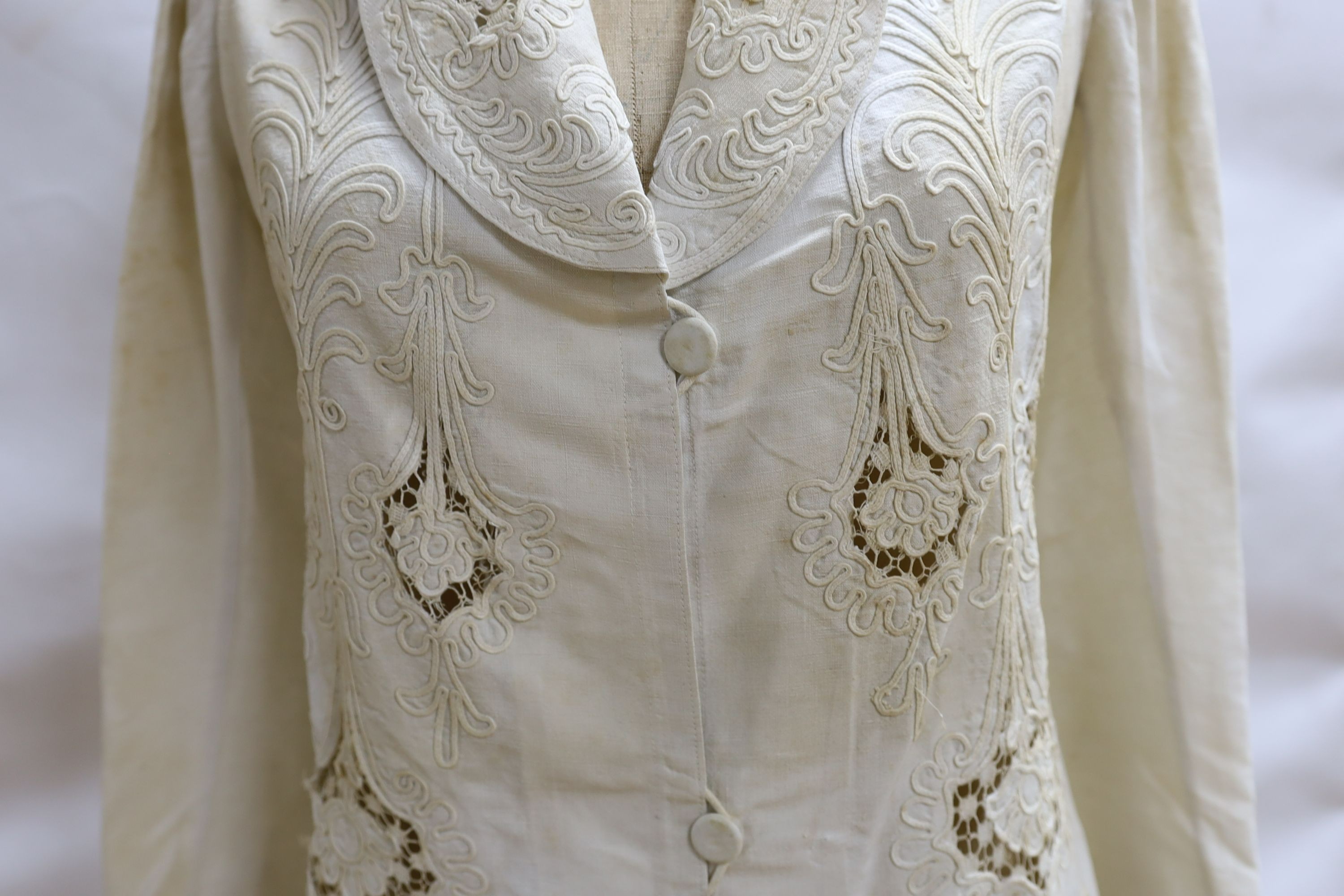 An Edwardian white/cream linen lady's coat with cut work detail and unusual button detail to the back